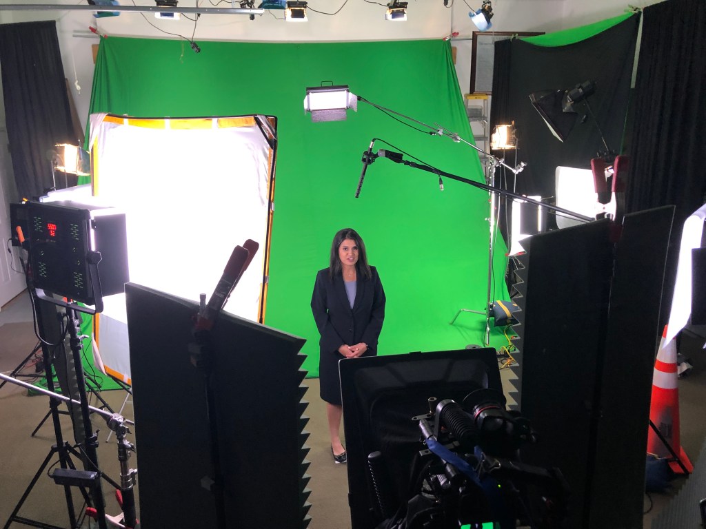 Recording non-professional talent with green screen at sound studio.